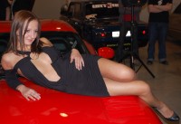 Девушка с красивой грудью на выставке Dreamcar Show 2010